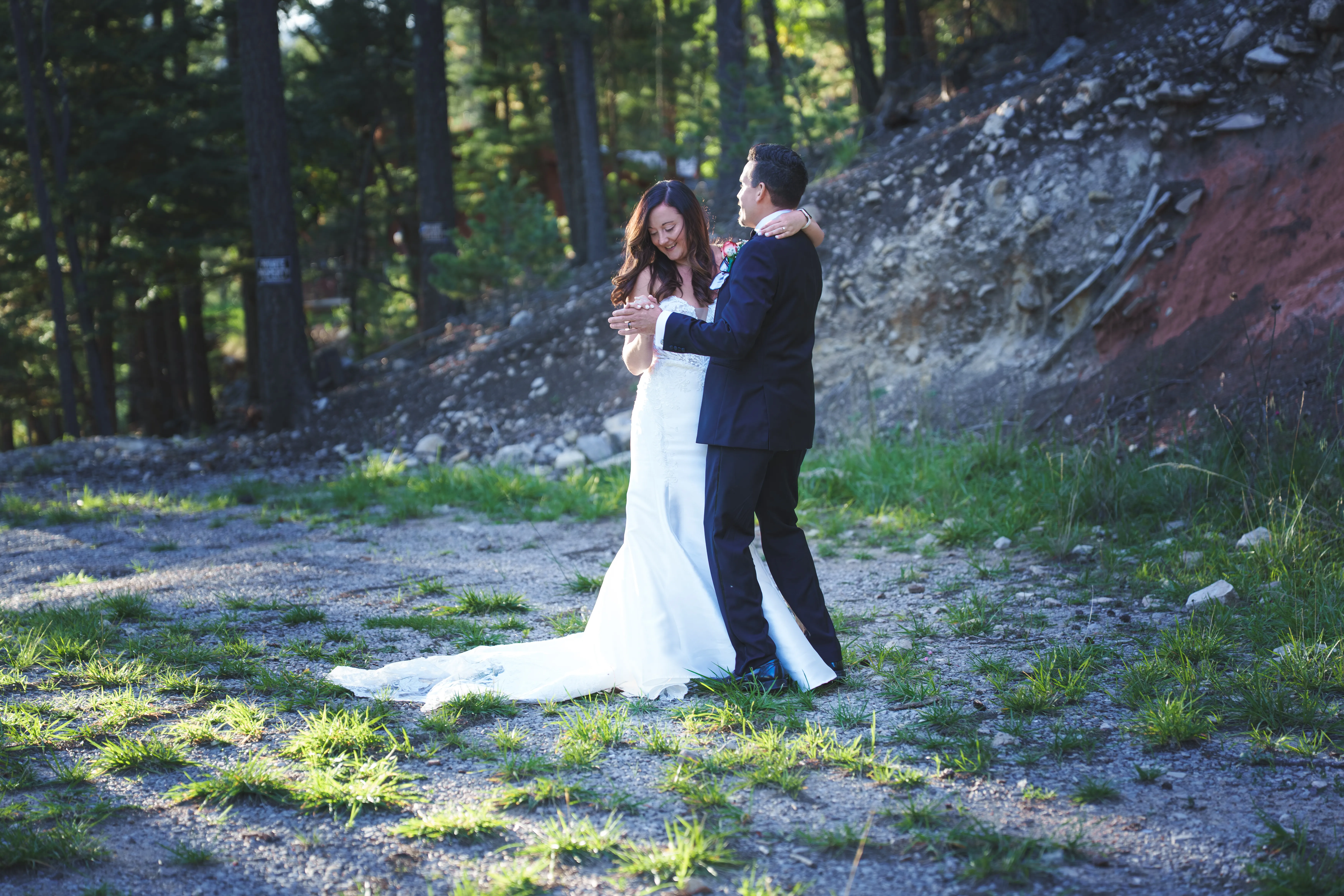 Wedding photography — couple dancing in forest light